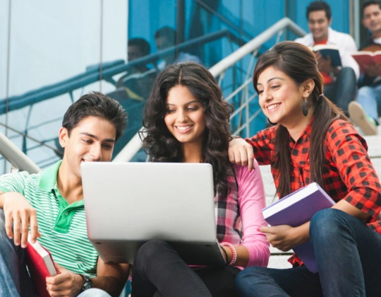Top Technical Training Course Institutes in Coimbatore Three young people studying with laptops, reviewing details about technical training courses.
